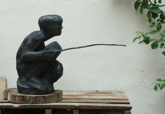 wooden sculpture fisherman